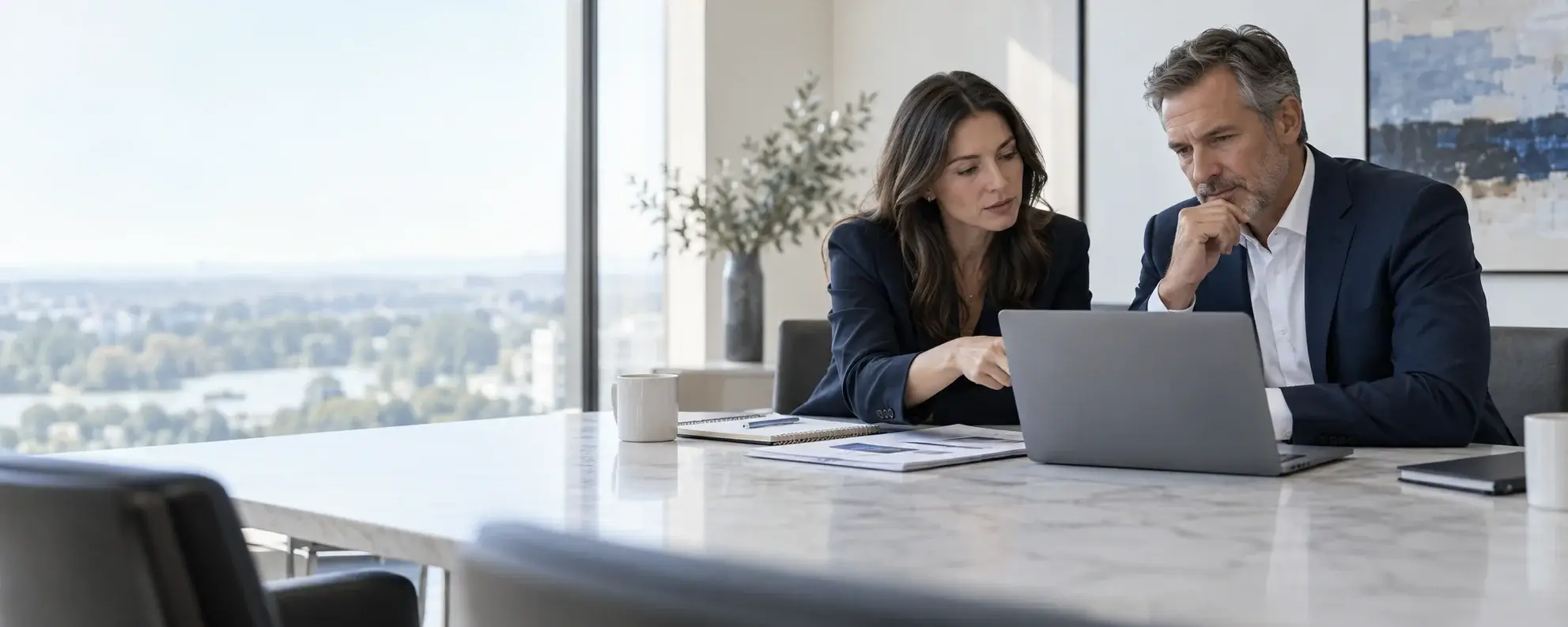 Consultants reviewing search visibility and content performance on a laptop in a modern office